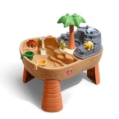 a toy boat with toys in it on a white surface and a palm tree behind it