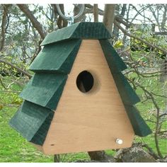 a wooden bird house hanging from a tree