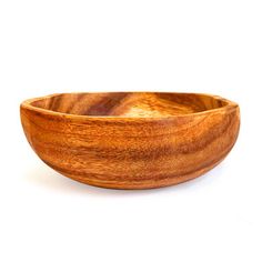 a wooden bowl sitting on top of a white surface