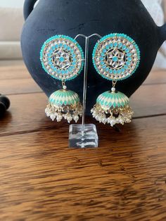 Statement earrings  Mint Colour Jhumka enamel  Kundan,Meenakari and faux pearl detailing  9cm in length  Any questions please feel free to ask Green Tilla Chandbalis For Party, Green Cutdana Chandbalis For Party, Green Kundan Chandbalis With Gota Work, Green Chandbalis With Gota Work For Festive Occasions, Heavy Green Jhumkas For Eid, Green Bollywood Chandbali Jhumkas, Green Chandbalis With Gota Work For Diwali, Green Latkans Earrings For Diwali, Festive Green Chandbalis With Gota Work