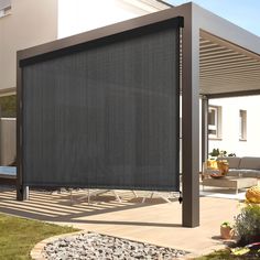 an outdoor area with a black shade covering the patio