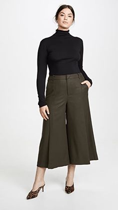 New with tags from High-end designer VINCE.A pleated front and wide leg adds a retro vibe to these soft flannel culottes. Fit: this style fits true to size. Size-00 Color-Army Green (Mineral Pine) - Zip fly with button closure - Front slip pockets - Back welt pockets - Front pleat - Belt loops - Solid color Fiber Content34% polyester, 33% viscose, 32% wool, 1% elastane Machine wash cold Green High-waisted Wide Leg Pants For Fall, Green Wide Leg Pants For Fall, Fall Pleated Wide Leg Pants, Chic Green Winter Bottoms, Chic Green Bottoms For Winter, Chic Wide-leg Fall Culottes, Chic Pleated Bottoms For Fall, Fall Pleated High-waisted Pants, Pleated Wide Leg Culottes For Fall