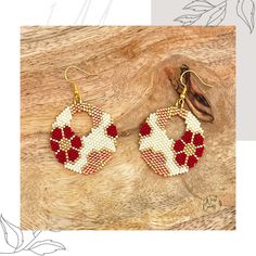 a pair of red and white beaded earrings