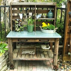 a potted plant sitting on top of a wooden table next to a garden shed