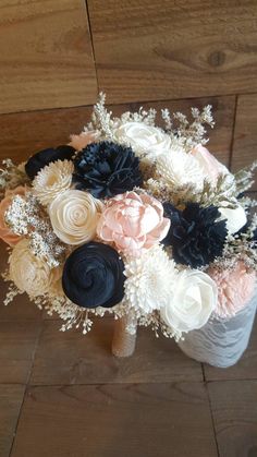 a bouquet of flowers sitting on top of a wooden floor