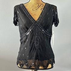 Nwt Adriannna Papell Boutique Beaded Sequin Top Black And Silver. Great With Long Skirt Or Palazzo Pants. Evening, Formal, Sleeveless And Form Fitting. Take It On Your Next Cruise! Pick Up This Beautiful Black Sequin And Beaded Evening Blouse For Your Next Holiday Party, Formal Event Or Maybe Just A Fancy Dinner. With Intricate Sequin And Beading You’re Sure To Shine! Pretty Flowing Cap Sleeve And Sequin Decoration Around The Breast Of Blouse. 100% Silk Shell With 100% Polyester Lining. Perfect Elegant Beaded Tops For Night Out, Elegant Beaded Black Tops, Elegant Black Beaded Top, Elegant Beaded V-neck Tops, Elegant Fitted Beaded Blouse, Black Beaded Blouse For Party, V-neck Beaded Blouse For Party, Fitted Beaded V-neck Blouse, Fitted Black Beaded Blouse