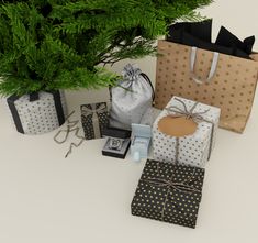 several gift bags sitting next to a tree