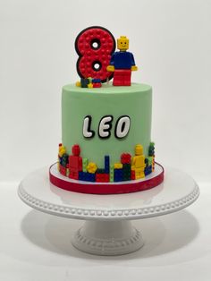 a lego themed birthday cake with the number 8 on top