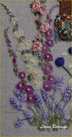 a close up of flowers on a piece of cloth with text overlay that reads cross stitch