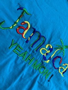 Vintage Jamaica Yeah Mon T Shirt Size Large but may fit smaller. See pics for measurements Quality Embroidered Graphic Aqua Blue with Multi Color Letters Fine condition Fast shipping. We ship same or next day with USPS We are a small family business and we appreciate your purchase, Godspeed ! Multicolor Letter Print T-shirt For Beach, Blue Embroidered Graphics Short Sleeve T-shirt, Vintage Jamaica, Blue Cotton T-shirt With Embroidered Logo, Badgers Logo, Blue Relaxed Fit T-shirt With Embroidered Logo, Jamaica Shirt, Champion Brand, Vintage Champion