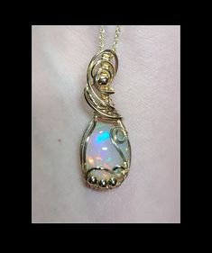 This pendant is made with a natural 4 carat Ethiopian opal that is wrapped in 14k gold filled wire.  This pendant is approximately 1.25 inches long. The pendant can be purchased with or without an 18 inch 14k gold filled necklace.  This opal has beautiful, multiple flashing colors including blue, teal, green, orange, yellow and red.  The pendant will arrive in a gift box. Yellow Gold Wire Wrapped Jewelry For Healing, Gold Wire Wrapped Freeform Jewelry, Gold Freeform Wire Wrapped Jewelry, Gold Freeform Wire-wrapped Jewelry, Unique Hand Wrapped Opal Jewelry, Spiritual Wire Wrapped Opal Jewelry, Spiritual Wire-wrapped Opal Jewelry, Unique 14k Gold Wire Wrapped Jewelry, Unique Opal Wire Wrapped Jewelry