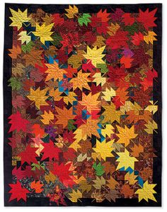 an image of a quilt made with autumn leaves on the front and back of it