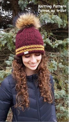 a woman wearing a knitted hat with a pom - pom on top