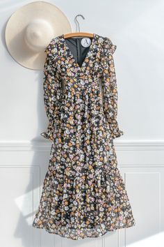 A lovely take on winter flowers, the Adeline maxi dress in black features pink, white, and orange floral print, long sleeves with smocked cuffs, a flutter shoulder detail, and a v neckline. Please Note- This item is final sale only. . Details: Small: Bust 32"-36", Waist 28"-30", Length 48" Medium: Bust 34"-38", Waist 30"-32", Length 48.5" Large: Bust 36"-40", Waist 32"-34", Length 49" Length Measured from Shoulder Length from Waist to Hem: 34" Lined Material: 100% Polyester Imported Hand Wash Co Black Long Sleeve Maxi Dress With Ruffle Hem, Spring Floral Long Sleeve Dress With Ruffles, Long Sleeve Ditsy Floral Maxi Dress For Garden Party, Ruffled Maxi Dress For Winter, Winter Ruffled Maxi Dress, Winter Maxi Dress With Ruffles, Fall Ditsy Floral Print V-neck Floral Dress, Black Floral Print Maxi Dress For Spring, Long Sleeve Floral Dress With Ruffles For Brunch