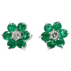 Capture the essence of spring with this stunning emerald and diamond flower stud earrings in 18 Karat white gold. Resembling petite green daisies each feature six emeralds totaling 1.56 carats. At the center of the blossoms, gleams two diamonds of G-H color and vs clarity, weighing a total of 0.40 carats. Simple yet elegant, these earrings make a perfect gift to celebrate the arrival of spring. You can complete the ensemble with a matching pendant for a polished finish: Link Assay mark: 750 12 e Emerald Flower Earrings, Snowflake Ring, Flower Stud Earrings, Flower Stud, Diamond Flower, Flower Earrings Studs, Flower Studs, Emerald Diamond, Flower Earrings