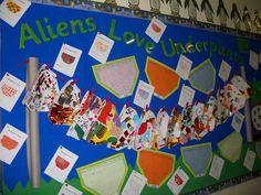 a bulletin board with lots of papers pinned to it and the words aliens love underpaint