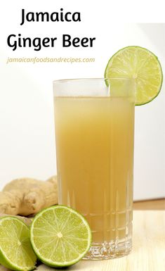 a glass filled with ginger beer next to sliced limes