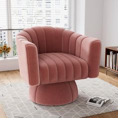 a pink chair sitting on top of a rug next to a window