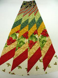 a multicolored christmas tree skirt with poinsettis