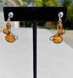 Cognac Amber Sterling Silver Earrings. Cognac amber stone set in .925 sterling silver.  Genuine Baltic amber earrings on silver post. Different styles to choose from. Amber Drop Jewelry With Matching Earrings, Amber Dangle Earrings For Formal Occasions, Amber Dangle Earrings For Anniversary, Amber Oval Jewelry With Matching Earrings, Classic Teardrop Amber Jewelry, Classic Amber Teardrop Jewelry, Hypoallergenic Amber Teardrop Jewelry, Cabochon Amber Earrings For Gift, Amber Cabochon Earrings For Gifts