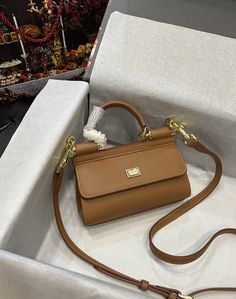 Description D.G Small Sicily Bag In Dauphine Brown For Women 7.5in/19cm DG Rep 1:1 Size: 19 x 13 x 6 cm / 7.5 x 5.1 x 2.3 inches (Length x Width x Height) Front flap with hidden magnetic fastening Branded plate featuring two metal plating finishes Top handle and adjustable, detachable strap in Dauphine Printed fabric lining and flat pocket Item comes with a branded dust bag Includes box, dust bag. This product is of the best quality. Dg Bag, Sicily Bag, Dolce And Gabbana Handbags, Luxury Products, Louis Vuitton Men, Evening Clutch Bag, Printed Fabric, Tote Backpack, Sicily