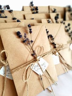 small brown envelopes tied with twine and lavender flowers