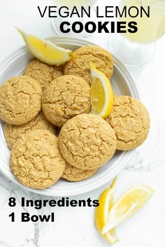 some cookies and lemons on a white plate