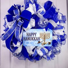 a blue and white wreath with a happy hanukkah sign on it