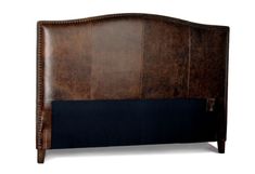 an upholstered headboard with studding and nail polishing on the sides