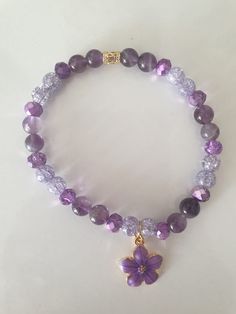 Flower Bracelet with Amethyst, cracked crystal and Rondelle crystal beads. The metal piece is gold plated brass.cracked crystal Length approx. 17.4cm.  The beads are 6mm.  Made with love. Amethyst is known for its strong connection to spirituality and its ability to provide clarity and insight. It is associated with both the Third Eye and Crown chakras, promoting spiritual growth, intuition, higher consciousness and creativity and bringing peace and calmness. The Amethyst cluster is not included Purple Flower Bracelet, Cracked Crystal, Handmade Bracelets Tutorial, Higher Consciousness, The Third Eye, Amethyst Cluster, Amethyst Jewelry, Bracelet Tutorial, Flower Bracelet