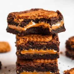 four brownies stacked on top of each other with caramel drizzle and frosting