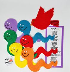 an assortment of different colored paper cut outs with birds and worms on top of them