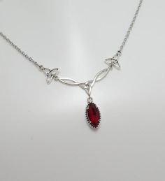 This is a new handmade necklace. It is made with antiqued silver plated Celtic knots, accented with a high quality DARK RUBY RED/GARNET glass jewel that sparkles like crystal. Decorated portion is 2 1/2" wide and 1 1/4" tall in the center. Necklace is adjustable 15-18" with a lobster clasp and chain extender. If you would like a different length, please send us a message.Matching earrings and headpiece are listed in our store in a variety of stone colors. If you don't see items with a color you Luxury Red Necklaces For Rituals, Red Gem Jewelry, Ruby Red Necklace, Red Stone Necklace, Celtic Goddess, Celtic Knots, Red Necklace, Red Jewelry, Garnet Jewelry