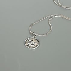 ▪︎ ONE sterling silver round charm with LOVE YOU inscribed on it. ▪︎ Size: 13 x 15 mm ( 17mm with hoop) Weight: 1.3 gm ▪︎ This is a multi functional charm and can be used with neck chains, ear hoops, bracelets, anklets, key chains etc. ▪︎ This pendant is handmade with hypoallergenic sterling silver, and is nickel free. Comes with a 925 mark for authenticity. ▪�︎ Please note: Price listed is for ONE charm. This pendant comes WITHOUT the chain, however, you can add a snake neck chain, bracelet chai Yin Yang Bracelet, Yin Yang Charm, Wanderlust Jewelry, Silver Wings, Gift Love, Neck Chain, Love Charms, Silver Pendant Necklace, Key Chains