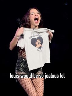 a woman holding up a t - shirt with the words louis would be so jealoous lol