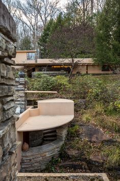 a stone bench sitting in front of a building