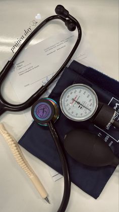 a stethoscope sitting on top of a medical bag next to a blood pressure meter