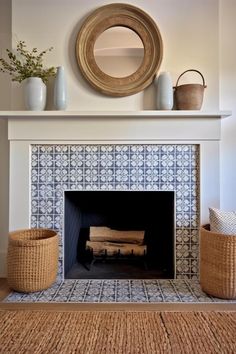 a living room with a fire place and baskets on the mantle