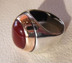 aqeeq red liver agate carnelian natural stone semi precious cabochon oval heavy man ring sterling silver bronze all sizes fast shipping Risk free Quality guarantee policy : If you are not satisfied with your item for any reason simply send it to us and you will get a replacement or refund . please write or choose your size with the order and we will size it for you . Our ring is handcrafted mostly with a few simple tools . but some methods are used in casting like lost wax method . sterling silv Anniversary Carnelian Signet Ring With Polished Finish, Red Oval Agate Jewelry, Polished Agate Oval Cabochon Rings, Polished Oval Carnelian Jewelry, Silver Carnelian Rings With Polished Finish, Oval Carnelian Jewelry With Polished Finish, Modern Red Cabochon Jewelry, Carnelian Oval Jewelry For Anniversary, Classic Oval Carnelian Jewelry