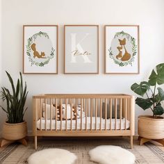 a baby's room with three framed pictures on the wall and two potted plants