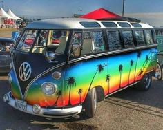 an old vw bus with palm trees painted on it