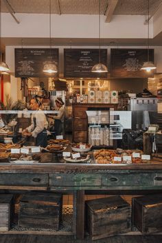 people working behind the counter at a bakery