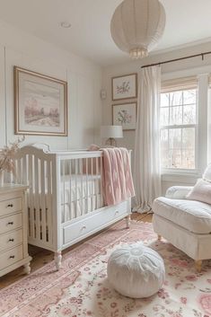 a baby's room with a white crib, pink rug and large window