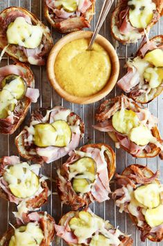 ham and cheese appetizers on a wire rack with dipping sauce