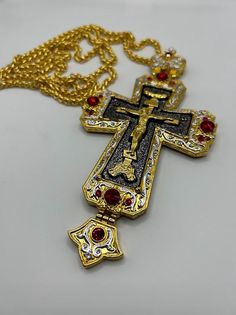 Priest pectoral cross, orthodox chest cross, brass cross in gold color with red stones, necklace with Jesus Crucifix, chain plated cross Made of brass. Decorated with red stones. This cross will come in a red gift box with a handmade embroidered bag. Standard delivery abroad takes 2-3 weeks. So if You need a product from our shop as a gift for a special event, please, be ready that the whole process will take a few weeks. We can add the gift card to the order. Red Crucifix Cross Necklace Gift, Red Crucifix Cross Necklace For Gift, Pectoral Cross, Red Gift Box, Stones Necklace, Red Stones, Knight Rider, Red Gift, Embroidered Bag