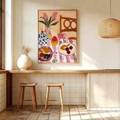 two wooden stools sit in front of a painting on the wall above a counter