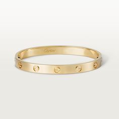 Cartier - LOVE bracelet - Bracelet Gold/Gold - LOVE bracelet, 18K yellow gold (750/1000). Comes with a screwdriver. Width: 6.1 mm. Created in New York in 1969, the LOVE bracelet is an icon of jewelry design: a close fitting, oval bracelet composed of two rigid arcs which is worn on the wrist and removed using a specific screwdriver. The closure is designed with two functional screws placed on either side of the bracelet: you will need help to open or close it. To determine the size of your LOVE bracelet, measure your wrist, adding one centimeter to your size for a tighter fit, or two centimeters for a looser fit. Please note that the carat weight, number of stones and product dimensions will vary based on the size of the creation you order. For detailed information please contact us. Oval Bracelet, Cute Skirt Outfits, Love Bracelet, Design Icon, Bracelet Collection, Cartier Love Bracelet, Jewelry Inspo, Love Bracelets, Bracelet Gold