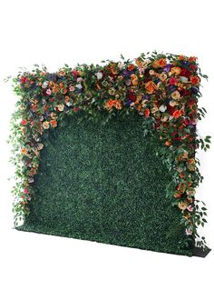 an artificial wall with flowers and greenery on it's sides, against a white background