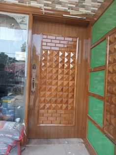 a wooden door with decorative glass and wood trim