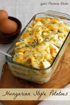 an egg and cheese casserole in a glass dish on a wooden platter